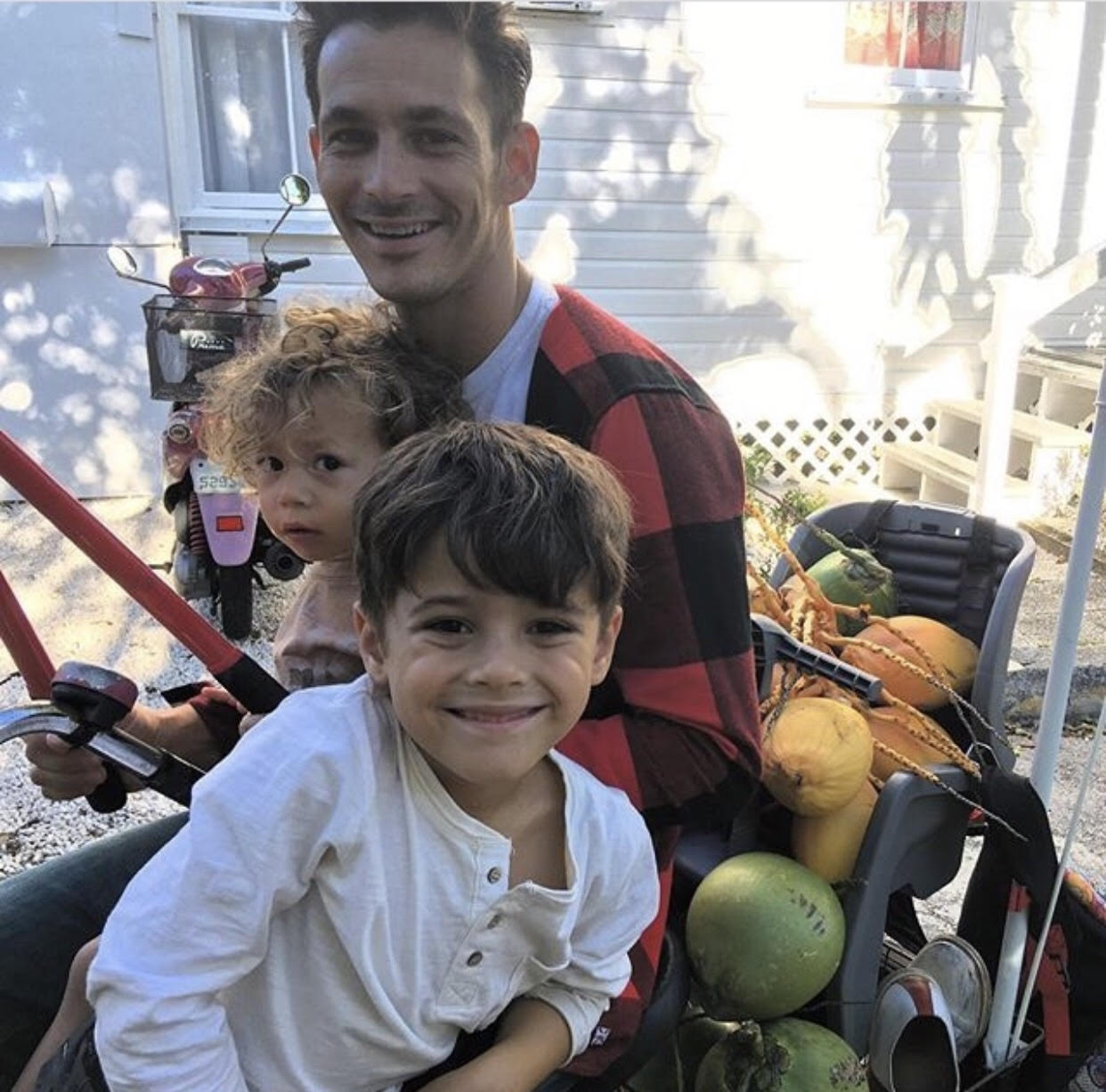 Familiar Faces of Fathers from Key West, Marathon, and the Upper Keys - A little boy sitting at a fruit stand - Jim Valvano