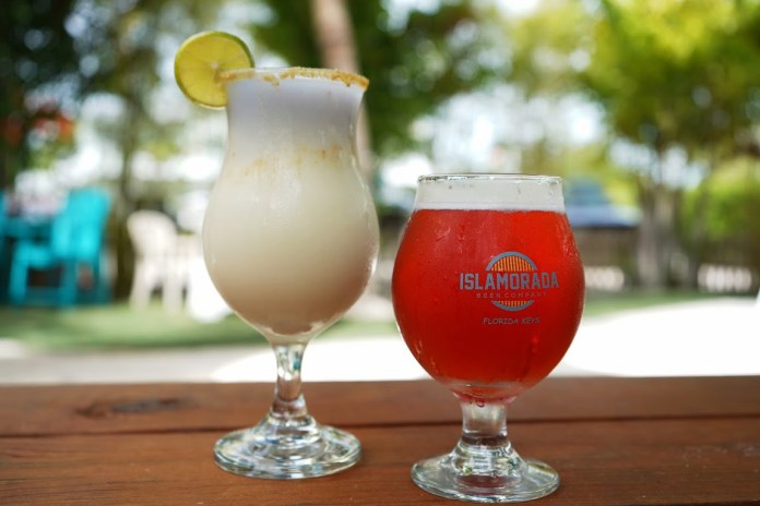 two drinks sitting on top of a wooden table