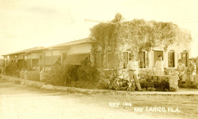 Key-Inn-Key-Largo a group of people standing in front of a house