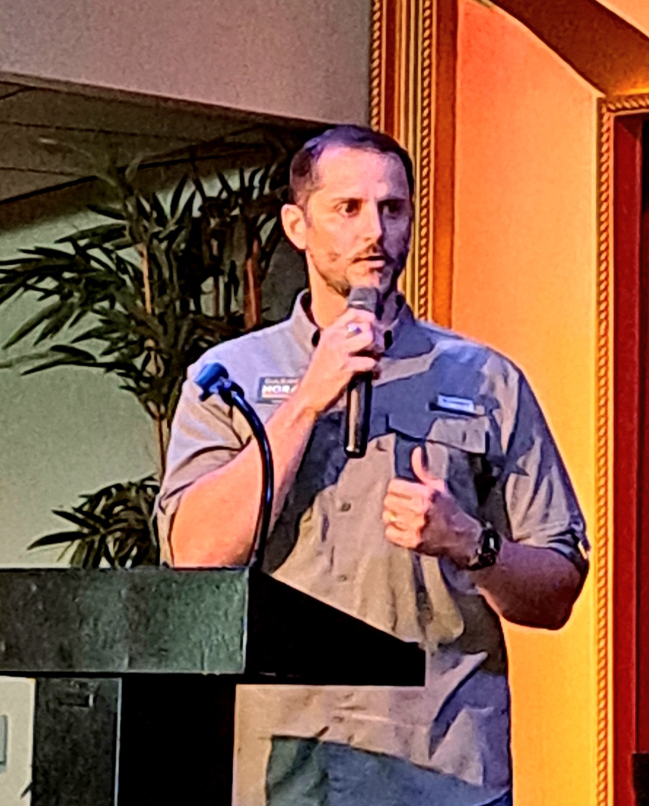 a man standing at a podium giving a speech