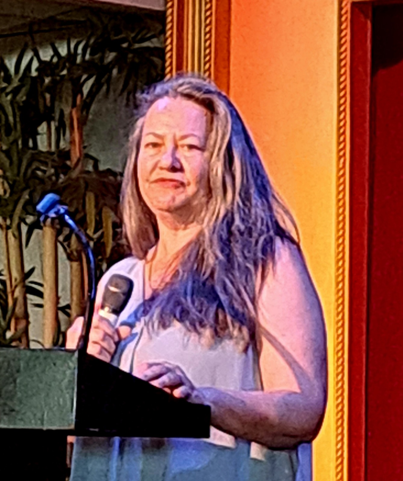 a woman standing at a podium with a microphone