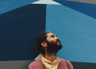 COLUMN: A LONG WALK ON THE BEACH WITH NATHAN LINEGAR a man standing in front of a colorful wall
