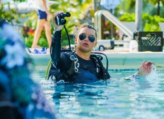 a man in a swimming pool with a camera