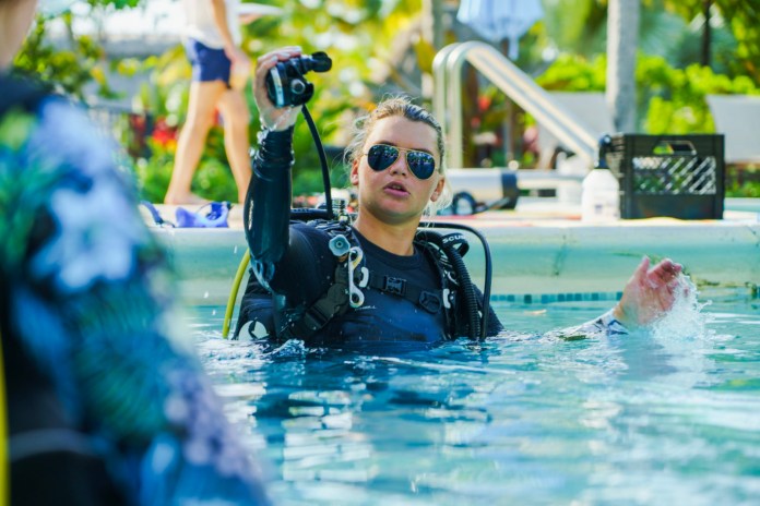 Instructors 2 a man in a swimming pool with a camera