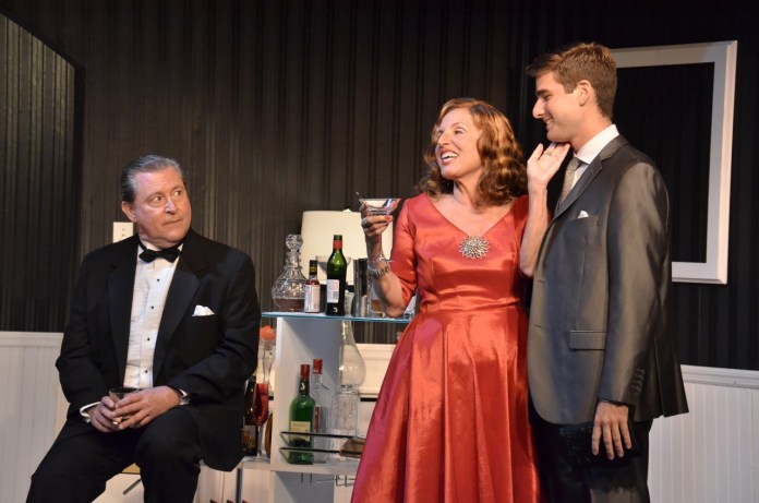 The Code at Red Barn Large a man in a tuxedo talking to a woman in a red dress