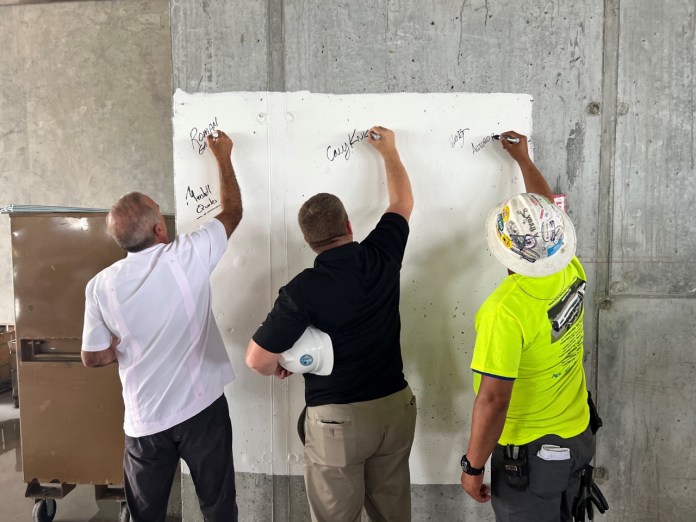 a group of men working on a wall