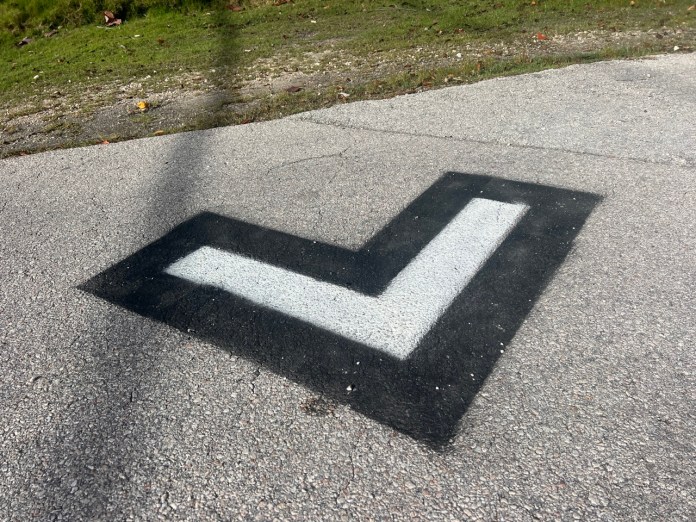 IMG_5686 Large a black and white arrow painted on a road
