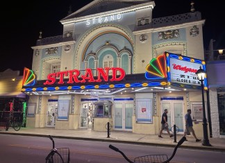 HISTORIC WALGREENS BUILDING ON DUVAL SELLS FOR $5.2 Million a large building with a neon sign on the front of it