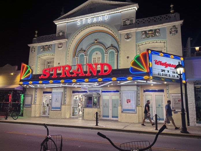 Strand2023 Large a large building with a neon sign on the front of it