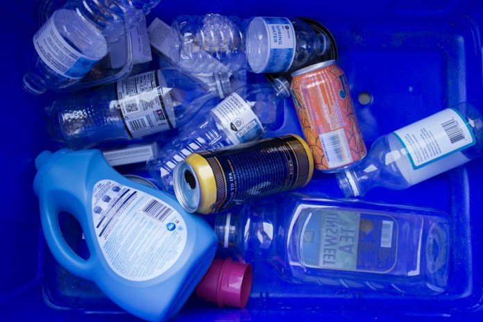 a blue container filled with lots of different types of bottles