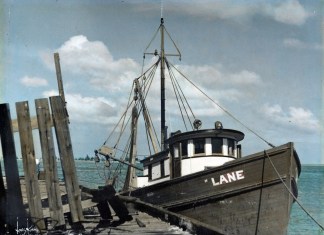 a boat sitting on top of a wooden dock