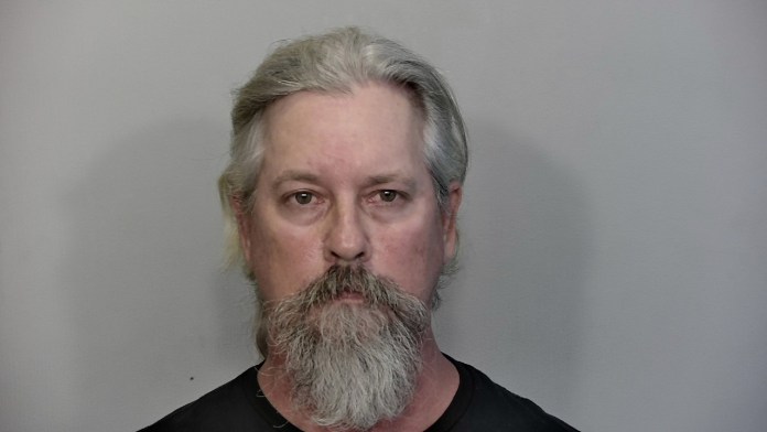 danielaross a man with grey hair and a beard wearing a black shirt