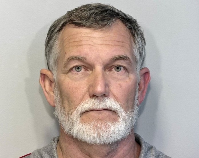 a man with a white beard and a gray shirt