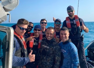 a group of people on a boat posing for a picture