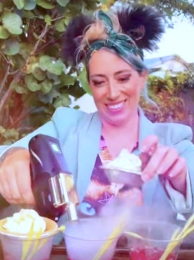 a woman is pouring something into a cup