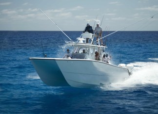 TEAM KILLBOX PREVAILS IN FOURTH ANNUAL MARATHON PREMIER SAILFISH TOURNAMENT a white boat with people on it in the ocean