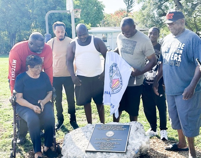 a group of people standing around a plaque