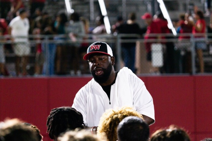a man sitting in front of a crowd of people