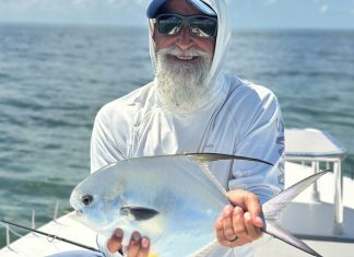 FLORIDA KEYS FISH REPORT: FALL FISHING BRINGS ITS OWN COLOR CHANGE TO FLORIDA BAY a man sitting on a boat holding a fish