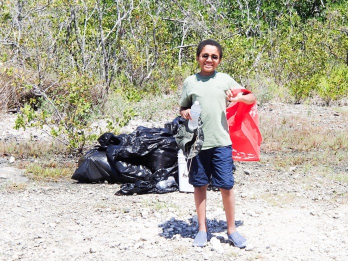 Pascal cleanup Large a man standing in the dirt with a red bag