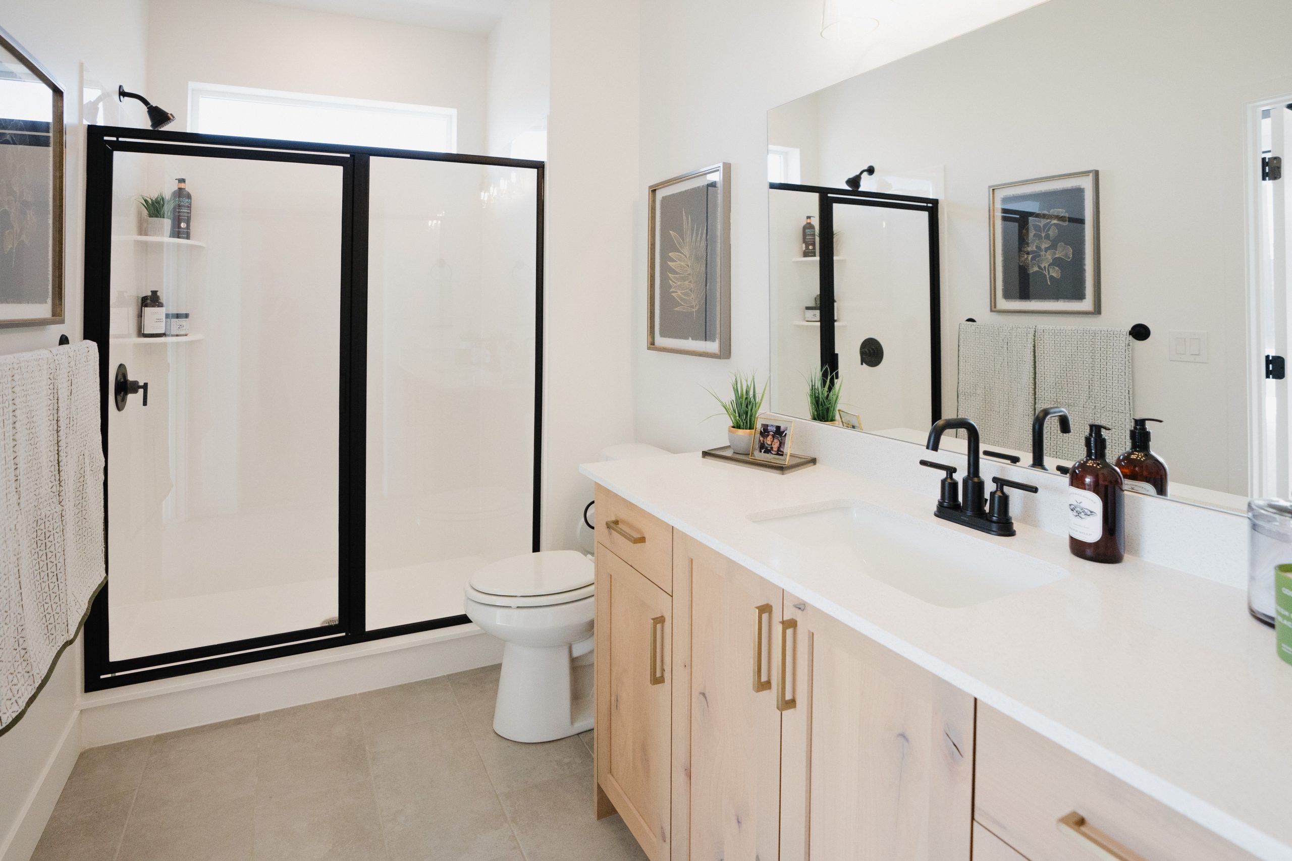 Modern bathroom featuring a black-framed shower enclosure