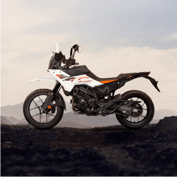 Adventure-ready KTM 250 riding through scenic mountain terrain, combining power and comfort