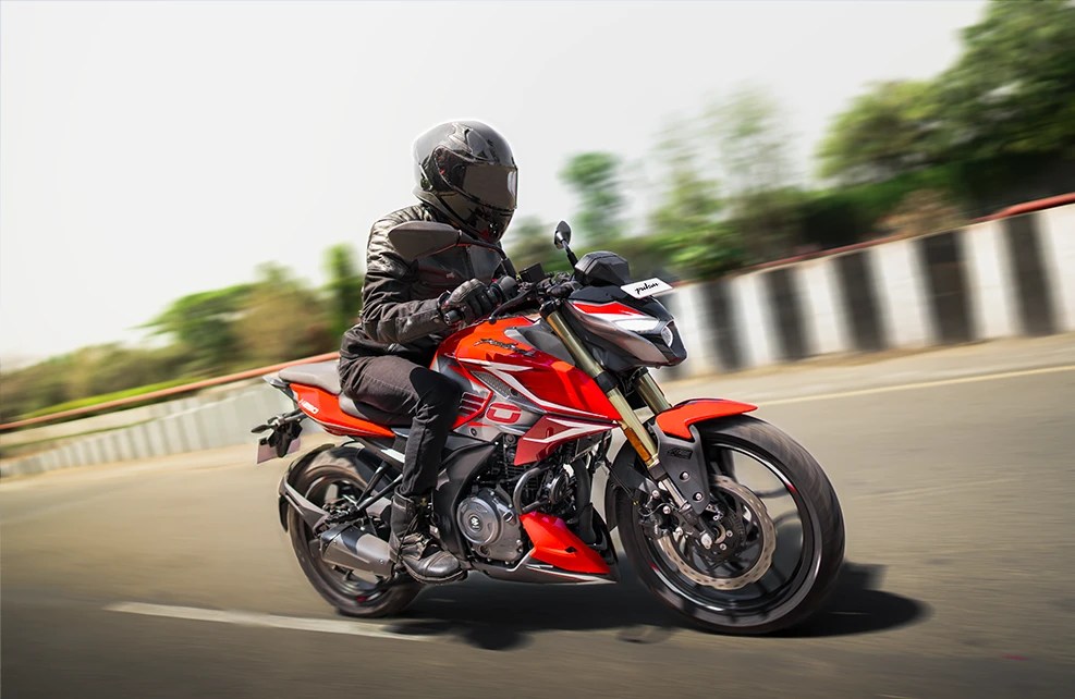 Front-facing Pulsar NS200 image showing aggressive riding posture and powerful engine pushing through wide highways.