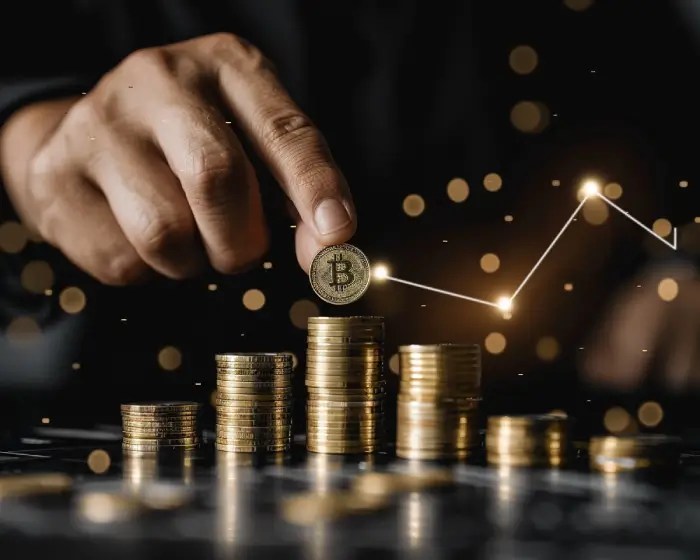 Stacking gold coins with a rising graph, symbolising Capital Raising Strategies for Innovation.