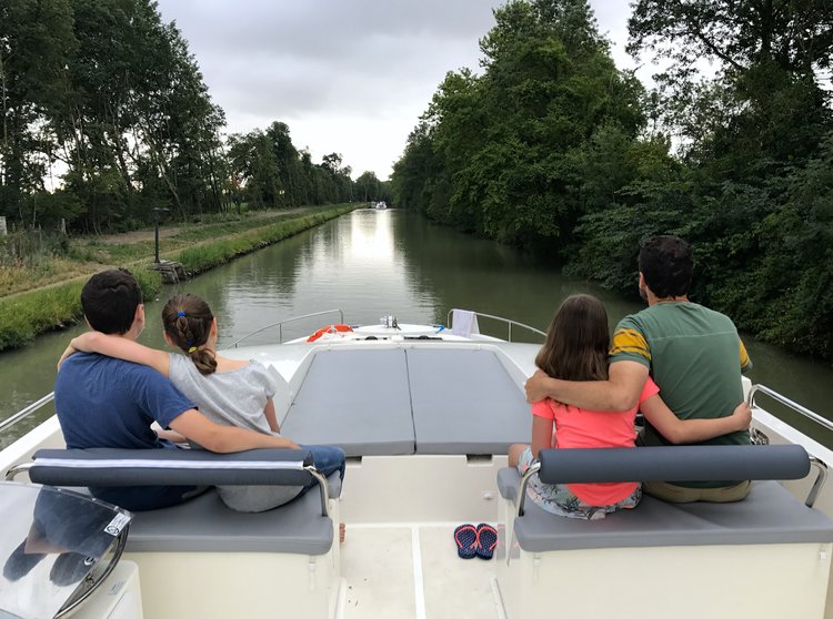 Kids sitting on a boat in France