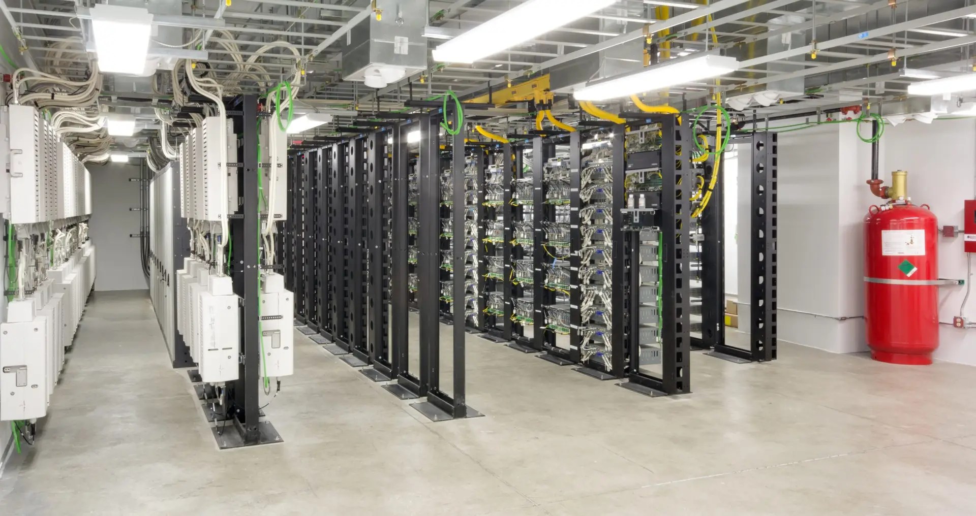 High-tech interior of AT&T data center at Reser Stadium with server racks, cooling systems, and advanced networking equipment.