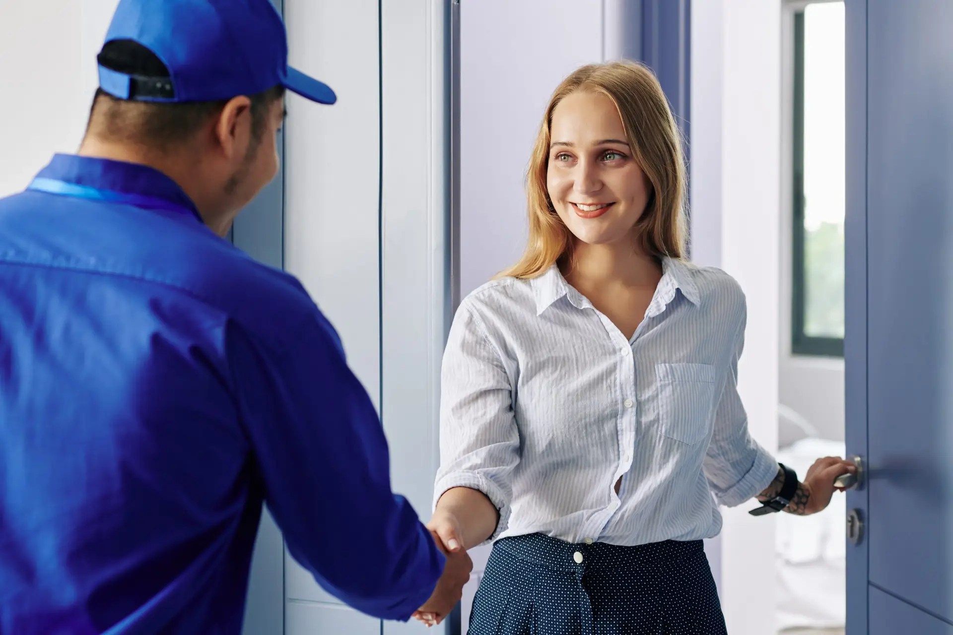 Smiling woman receiving warranty service from a professional, highlighting customer satisfaction and reliable support.