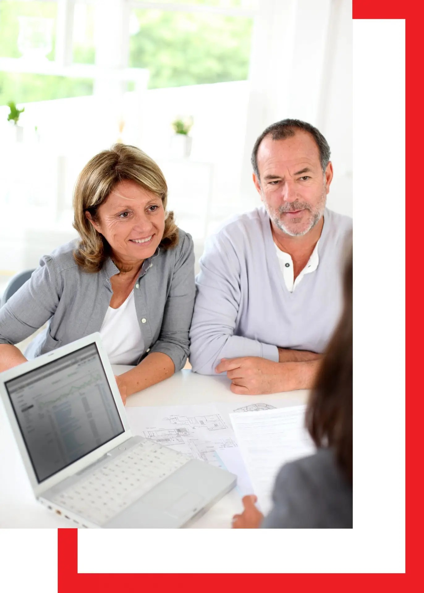 Smiling couple signing a contract with Kimball Construction representative, showcasing trust and professional service.