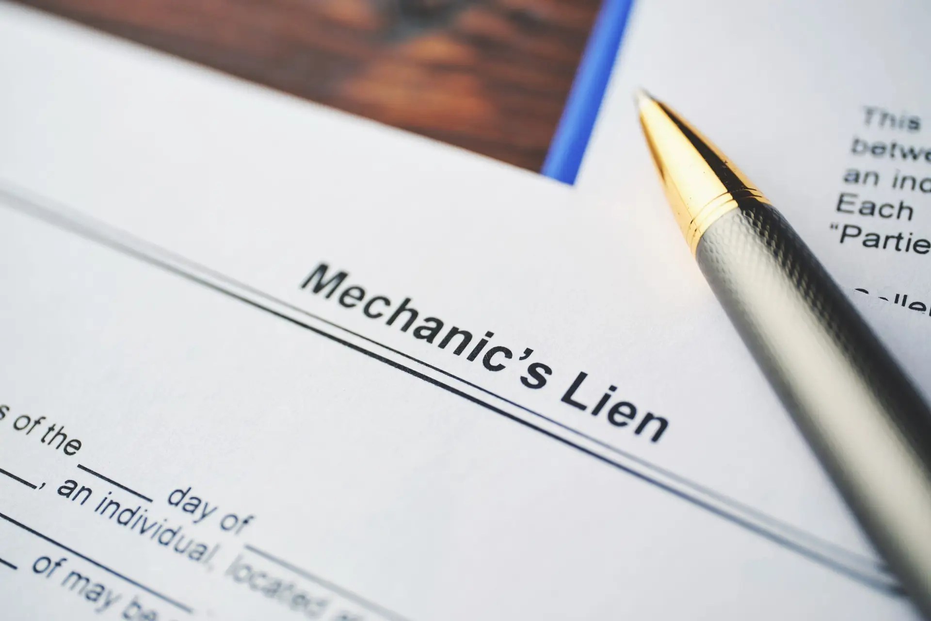 Close-up of a construction lien document with legal terms and financial details, used for securing contractor payments.