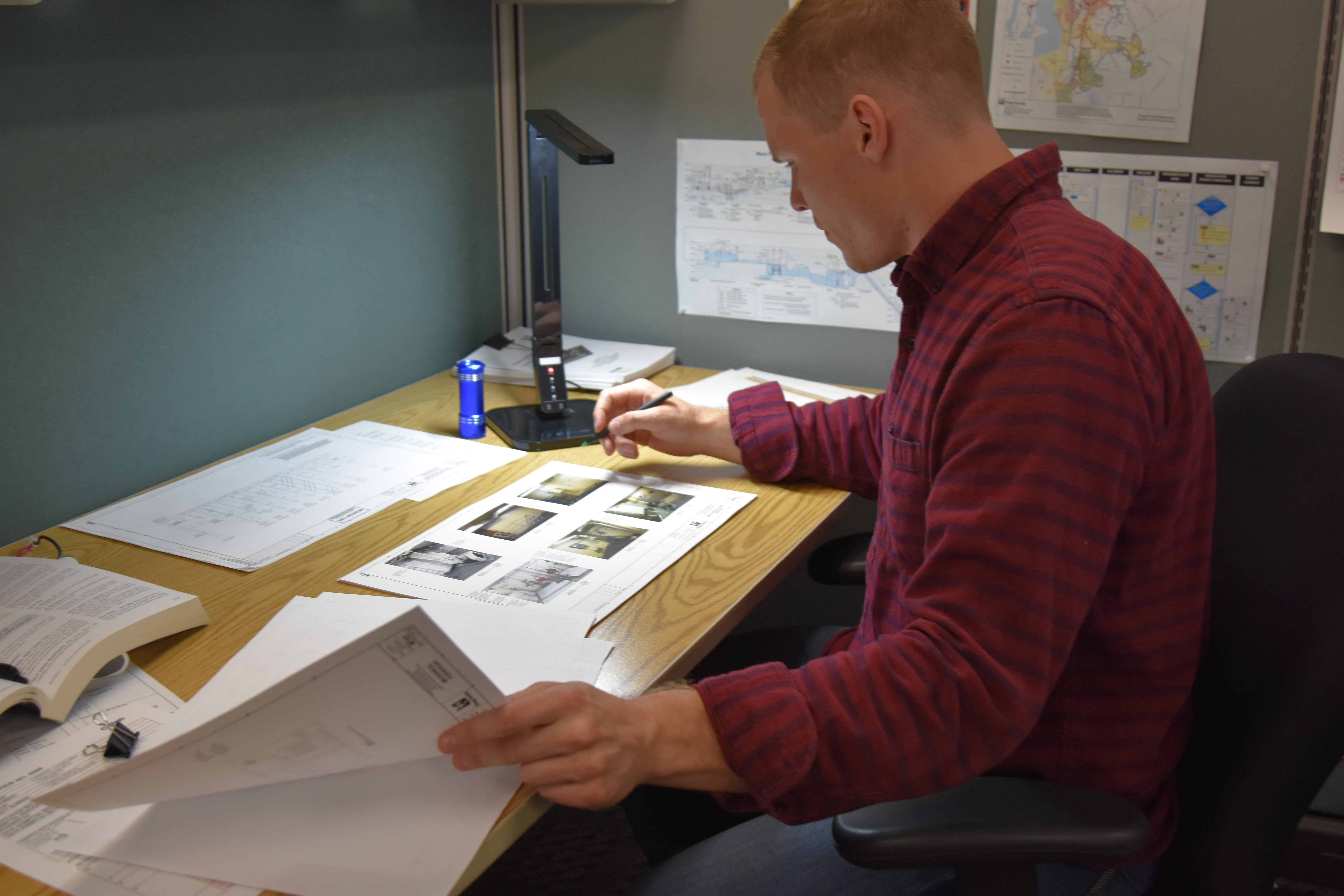 Engineer Sammy Wood studies technical drawings