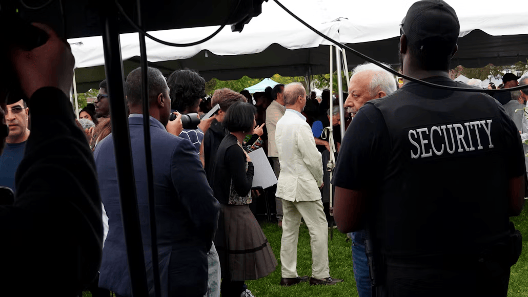 Security guard monitoring guests at an outdoor event tent