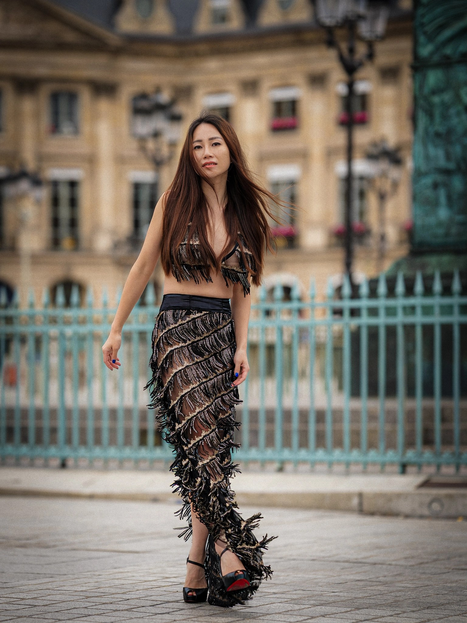 Lily Stadil walks through Place Vendôme in a beaded BRAXTON look