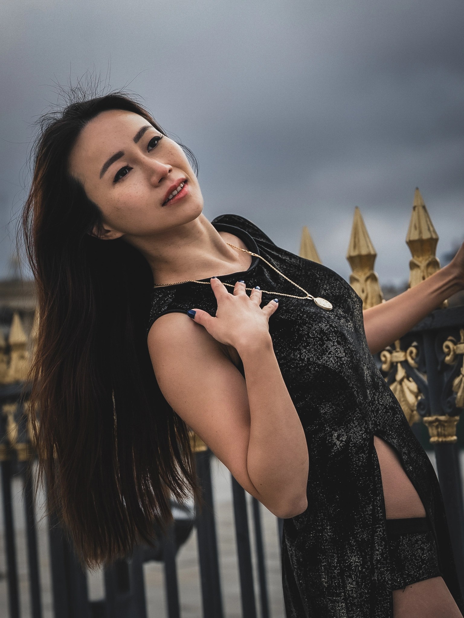 Close portrait of Lily Stadil in a black BRAXTON dress at Place de la Concorde