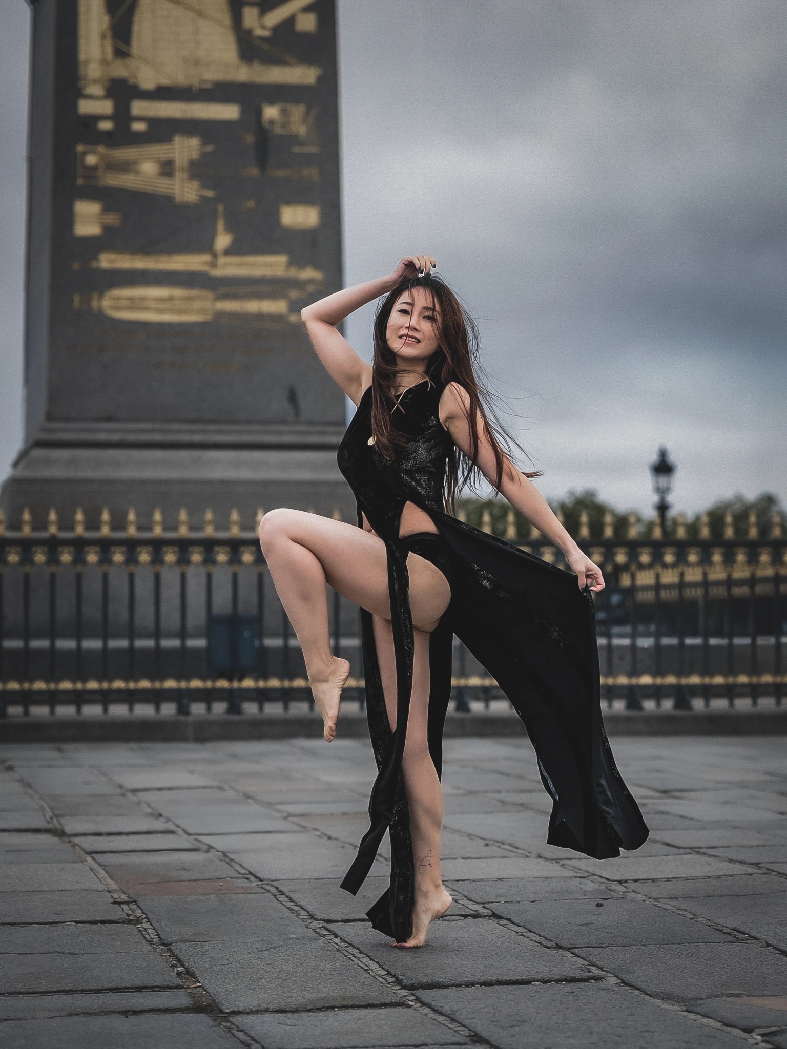 Lily Stadil raises one knee while dancing before the Luxor Obelisk