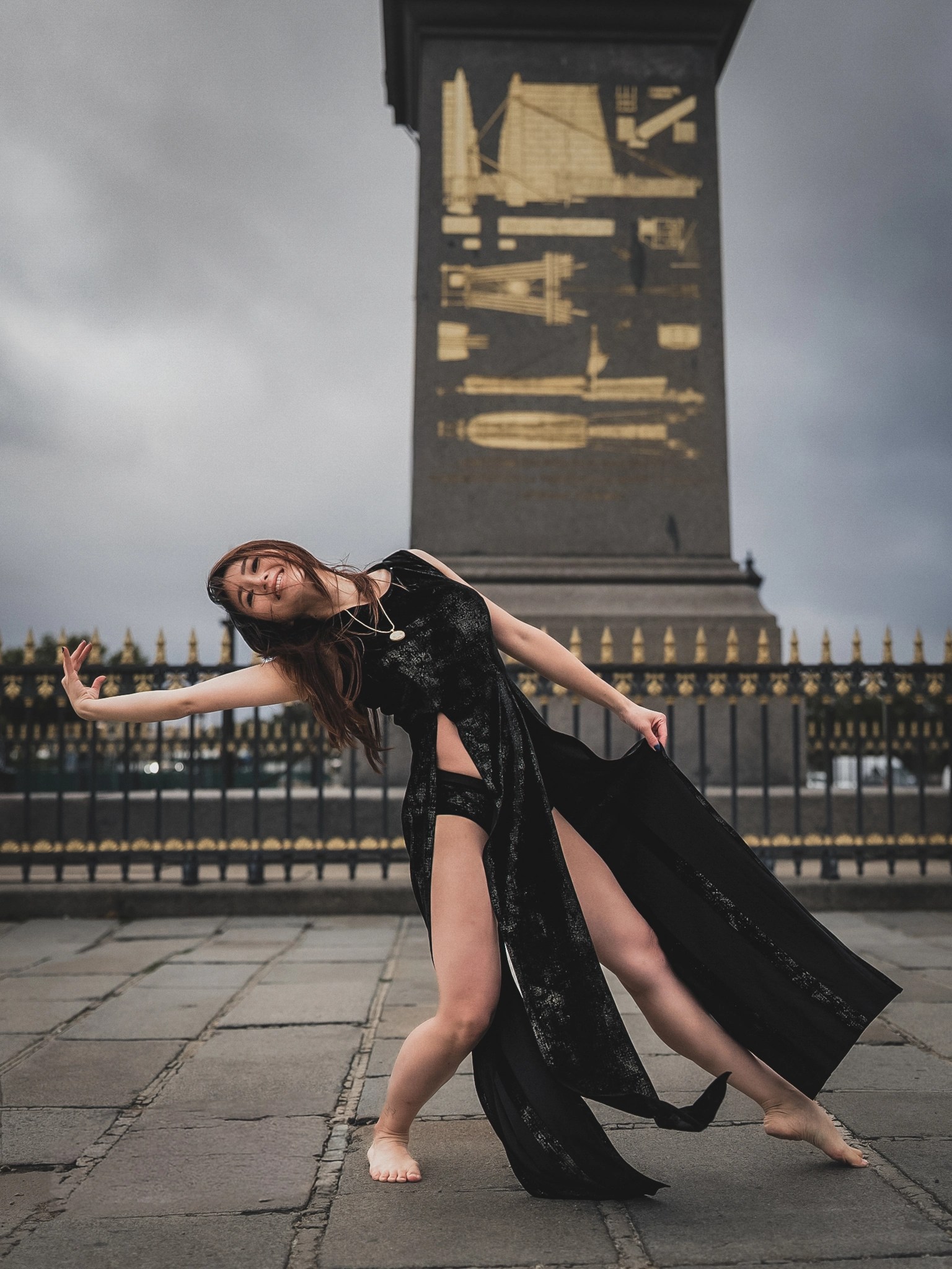 Lily Stadil leans into a dance pose before the Luxor Obelisk