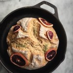 Photograph of orange-rosemary soda bread made using whole grains in a cast-iron skillet