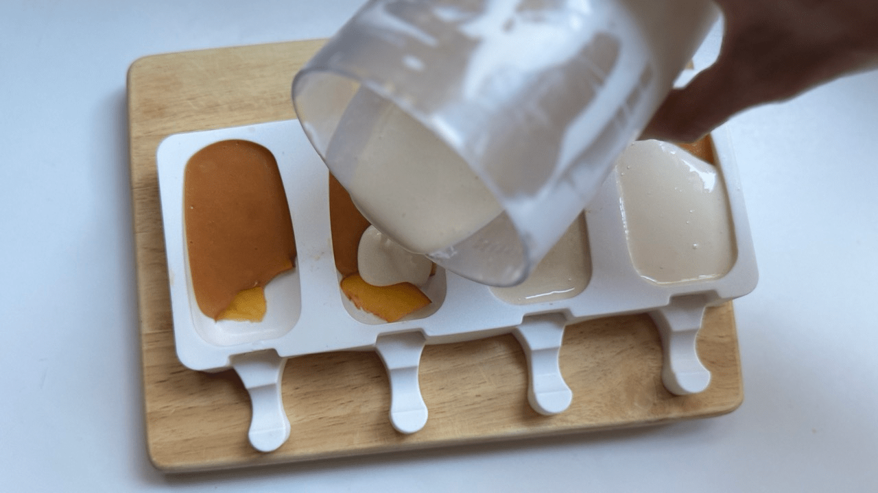 yogurt amazake base pouring the ice pop mold
