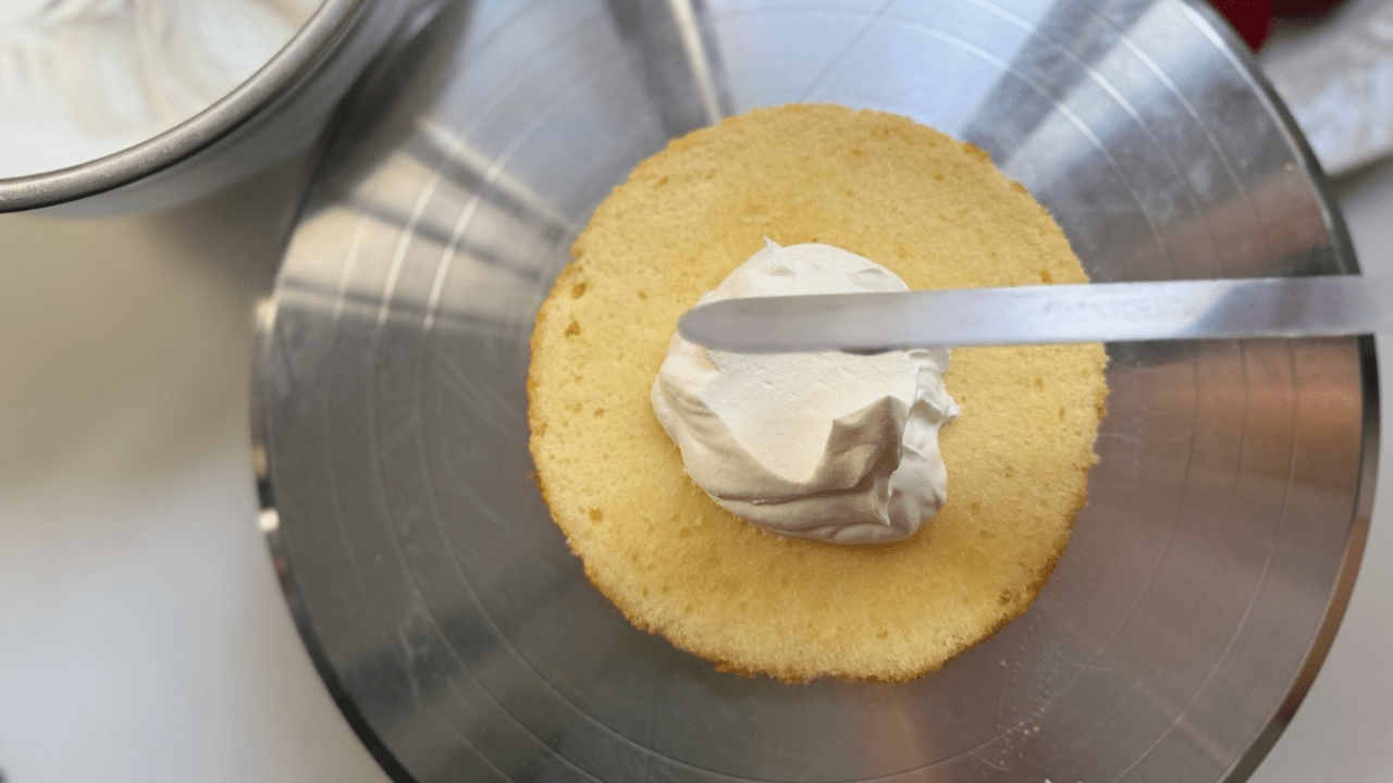 spreading the cream for strawberry short cake