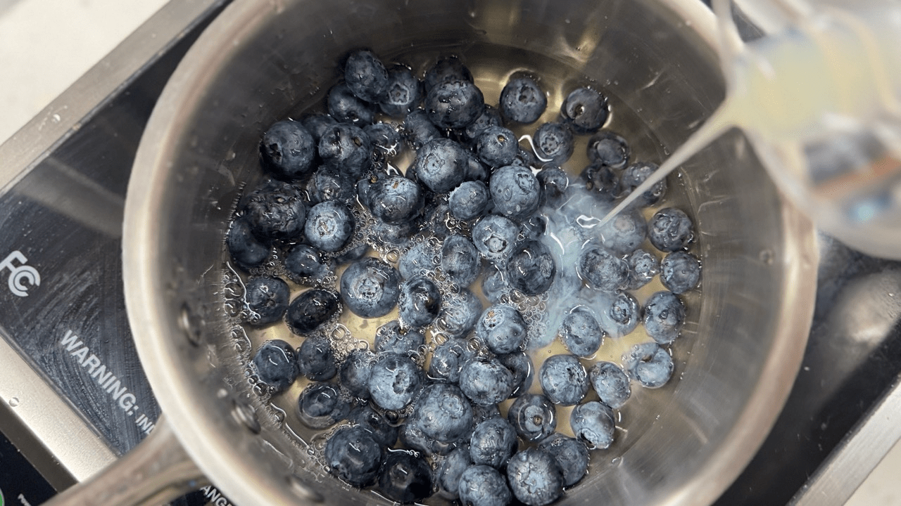 adding blueberry in the sauce pan