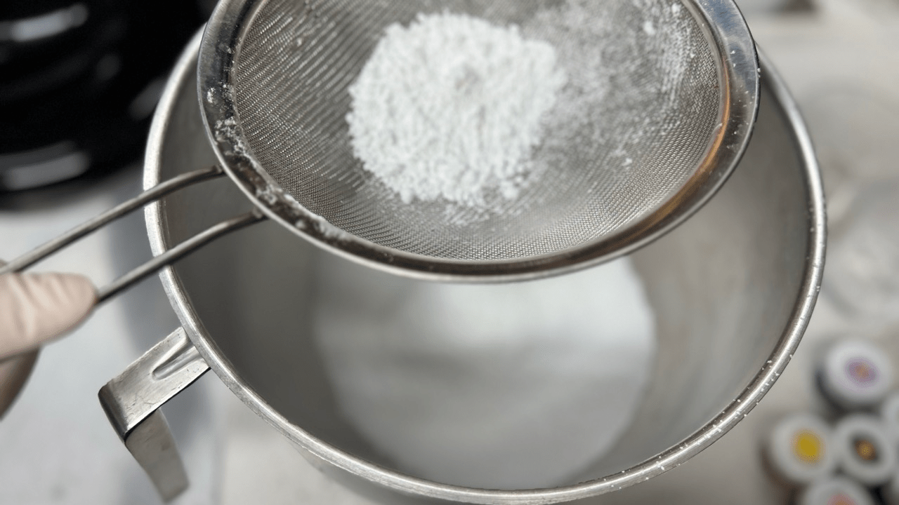 straining the powdered sugar