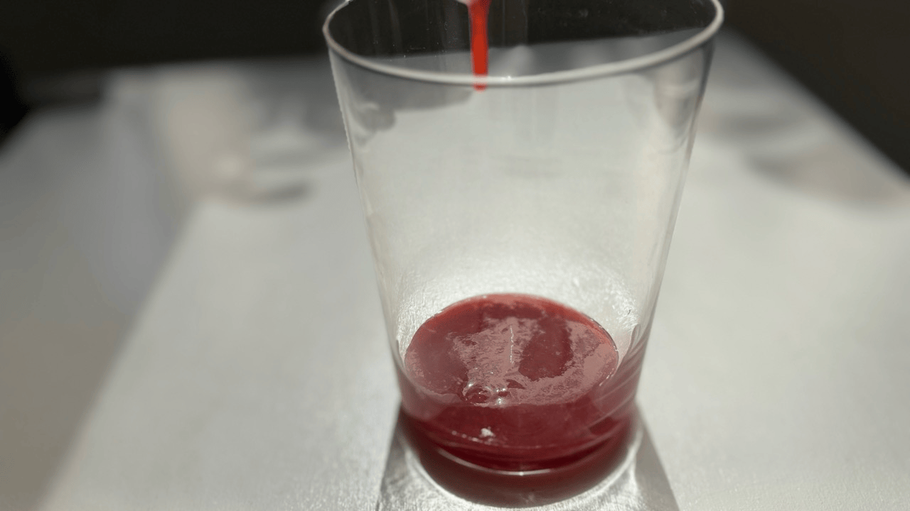 adding strawberry sauce in to the glasses