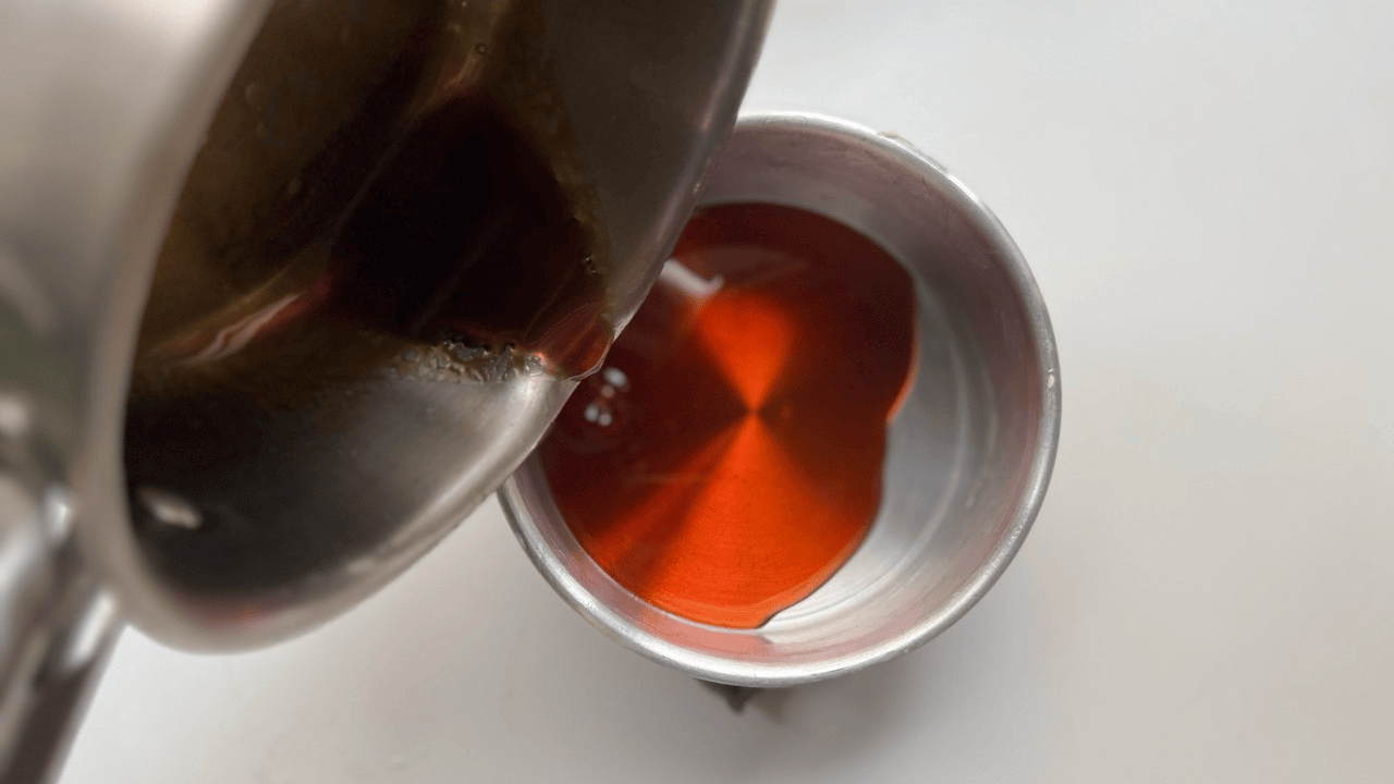 pouring caremel into the 6 inch mold