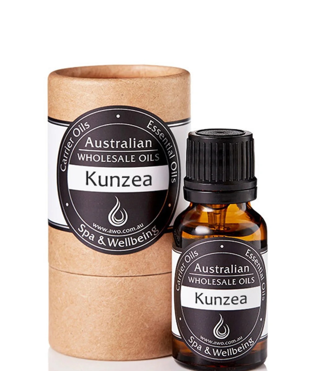 A small amber bottle of Kunzea Essential Oil – 100% Pure Australian Oil stands next to a matching cylindrical box, both featuring Australian Wholesale Oils, Spa & Wellbeing branding to showcase this premium product.