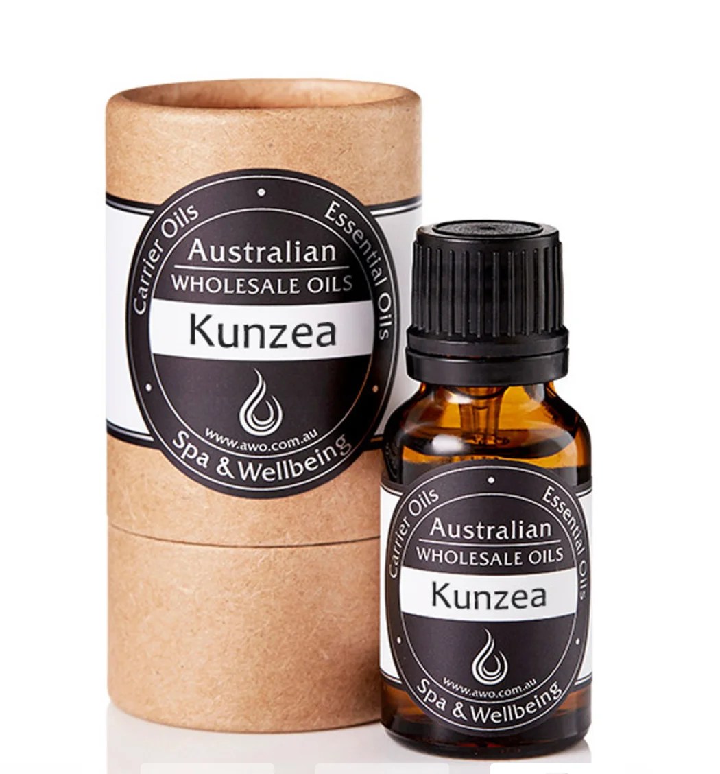 A brown glass bottle labeled Kunzea Essential Oil – 100% Pure Australian Oil stands beside a matching cylindrical cardboard container with similar branding, both displayed on a white background.
