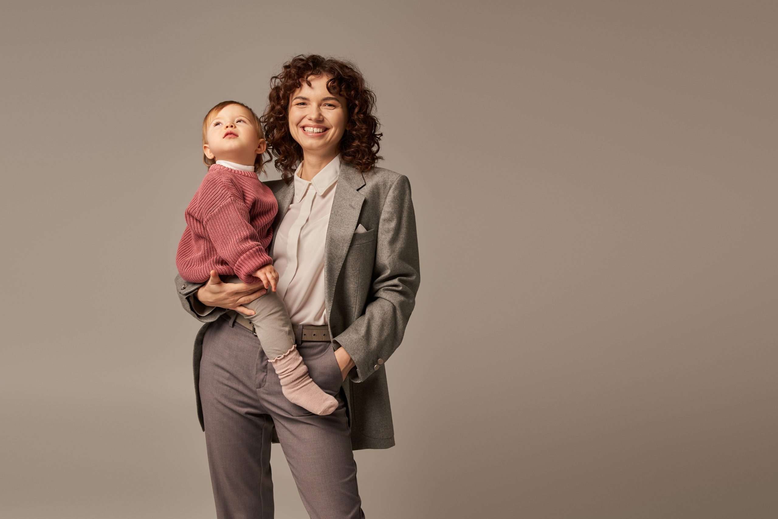 Work,Life,Balance,Concept,,Cheerful,Woman,In,Suit,Holding,Daughter