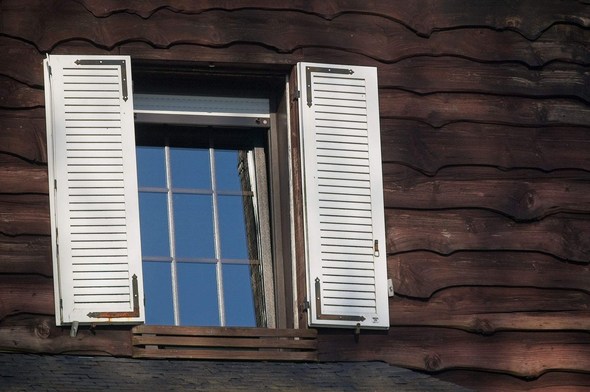 white shutters on wooden house